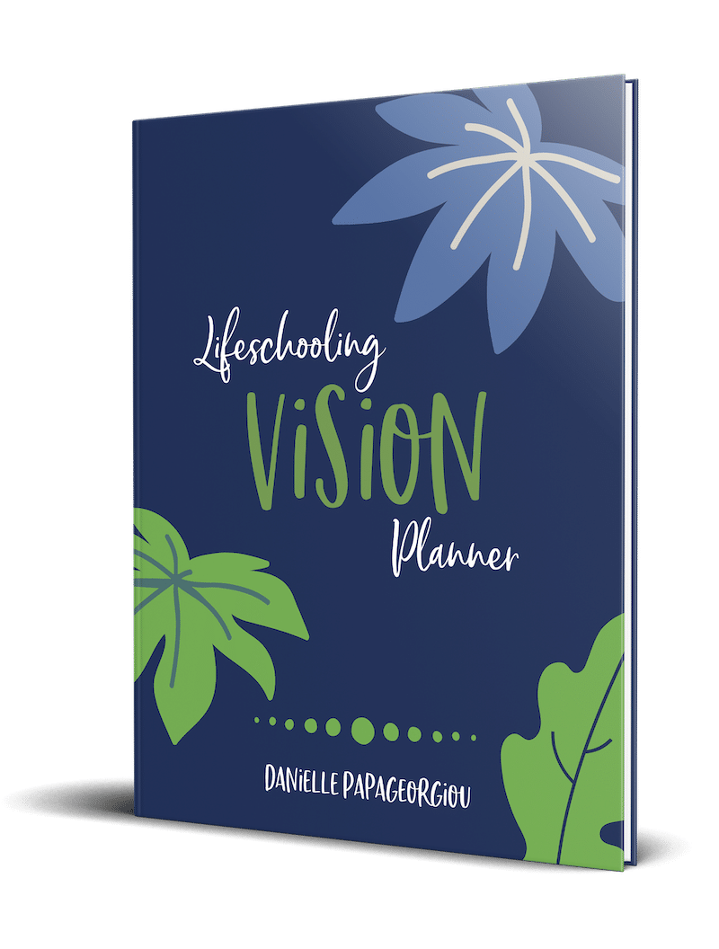 picture of the Lifeschooling Vision Planner standing upright. It is navy with light blue and green leaves on the cover.