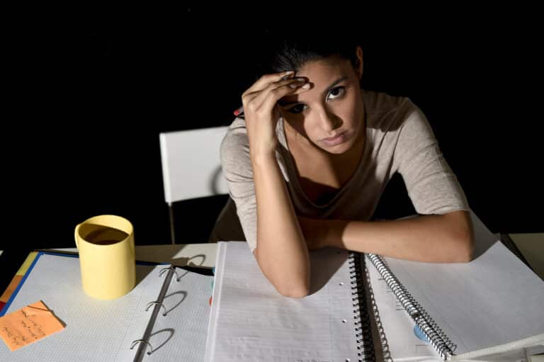 overwhelmed woman with coffee cup trying to plan