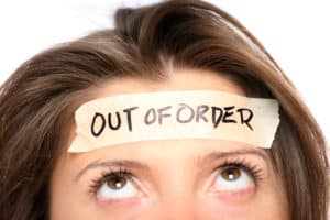 woman with "out of order" written in tape across her forehead.