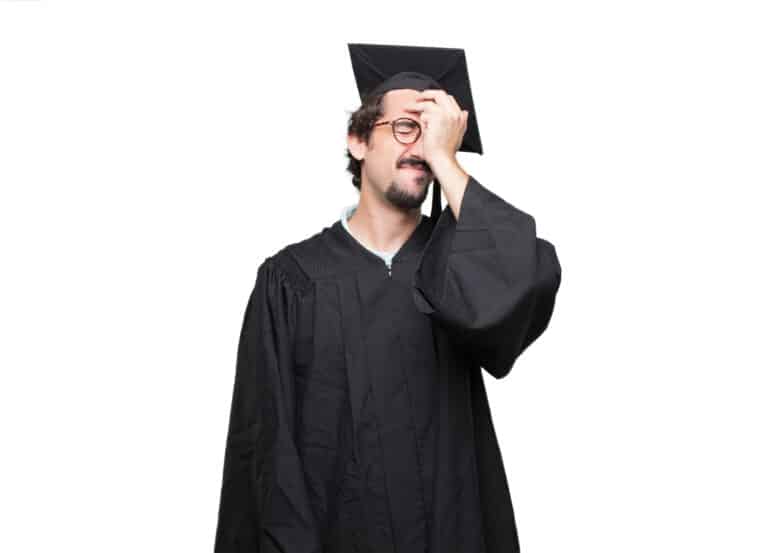 college graduate with hand on head, feeling frustrated