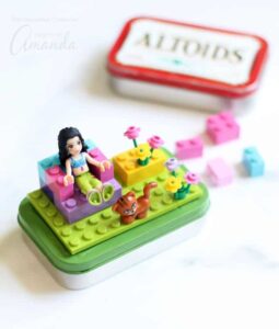 Altoids tin with legos attached to the top