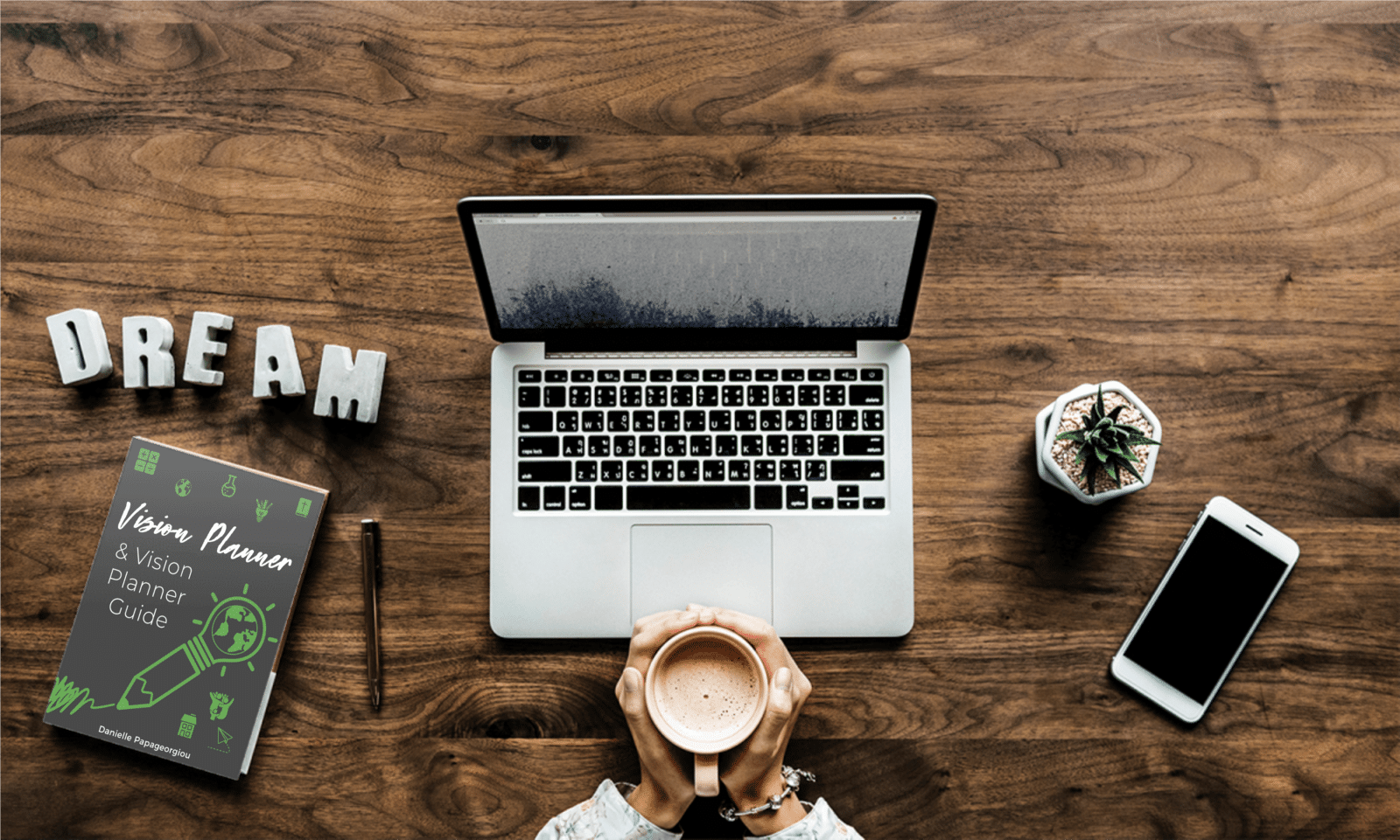 lifeschooling vision planner sitting on a desk near a laptop with the word "dream"